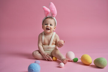 Obraz na płótnie Canvas Smiling caucasian baby in rabbit costume at the studio