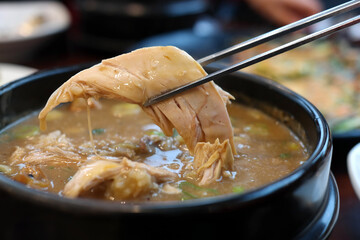 Korean health food cooked with medicinal herbs and glutinous rice in chicken.