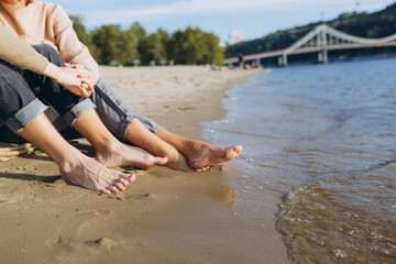 Male and female legs on the beach. Place for inscription