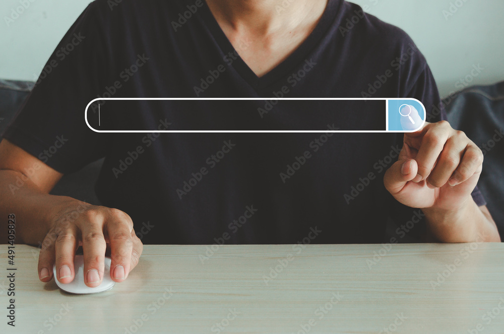Aufkleber hand touches the virtual screen searching icon for web search engine and holds the mouse on the tabl