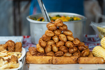 Fried chicken and vegetables spring rolls at street food market in Thailand