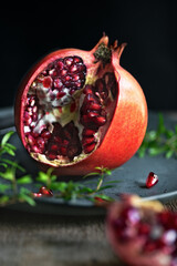 Pomegranate on a plate on a wooden board