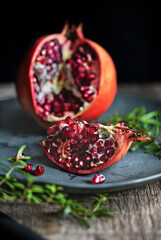 Pomegranate on a plate on a wooden board