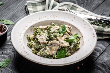 Mushroom and Spinach Pasta in a Bowl, Vegan Food on light background. Vegan or gluten free diet. banner, menu recipe place for text, top view