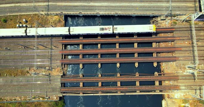 local train moving over mith river near bandra station drone shot mumbai india  top view birds eye view