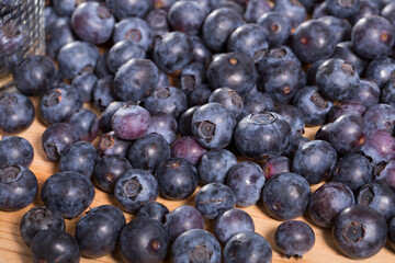 Fototapeta premium Fresh delicious blueberries on wooden table. High quality photo