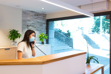 Receptionist speaking on phone at physiotherapy centre