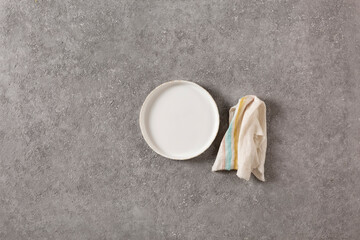 Empty vintage white plate on gray concrete empty background. Food and cooking concept, copy space for text or advertisement