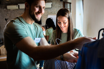 Group of volunteers working in community charity donation center.