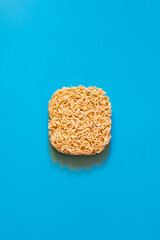 Raw noodles on the blue background	