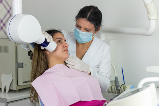 A radiologist take a picture of teen girl patient in the X-ray dental office in the hospital