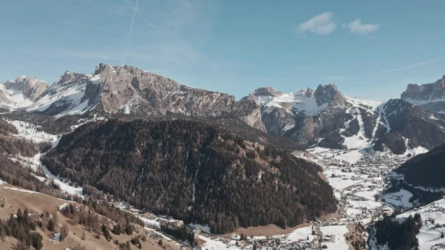 Slider drone shot over Selva Wolkenstein valley dolomites