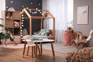 Comfortable house bed in child room. Stylish interior