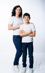 mother with son in jeans and white t-shirts on a white background. motherhood concept