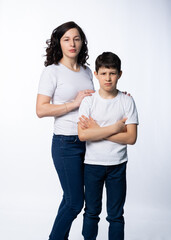 mother with son in jeans and white t-shirts on a white background. motherhood concept