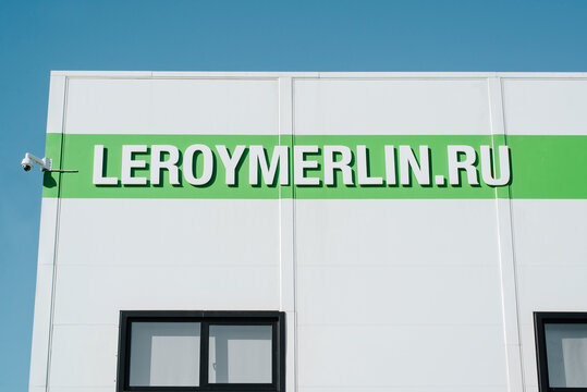 Facade of Leroy Merlin building logo of French company, construction hypermarket for home and garden on sunny day outdoors. Smolensk, Russia 02.03.2022
