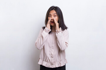 young asian beautiful woman shouting and yelling announcing isolated on white background
