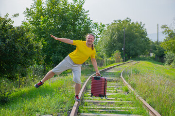 an adult passenger runs along the sleepers behind the train
