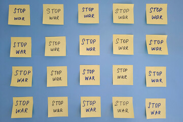 A lot of yellow stickers with words on blue background close up. Flat lay. Concept of freedom and...