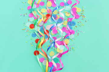 Party colorful confetti over pastel blue background. Top view, flat lay