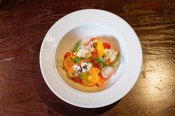Salad with herbs, radishes and tomatoes.