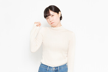 白背景の前に立って怒っているジェスチャーをする女性