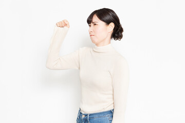 白背景の前に立って怒っているジェスチャーをする女性