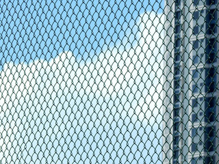 wire mesh of fence with blue sky background
