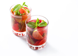 Refreshing summer cocktail with strawberry, mint, lime on white background. Selective focus.