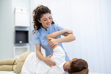 Physiotherapist treatment patient. Holding patient's hand, shoulder joint treatment. Physical Doctor consulting with patient About Shoulder muscule pain problems Physical therapy diagnosing concept