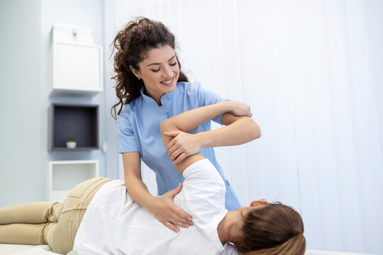 Physiotherapist treatment patient. Holding patient's hand, shoulder joint treatment. Physical Doctor consulting with patient About Shoulder muscule pain problems Physical therapy diagnosing concept