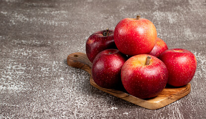 Fresh red apples on a brown table. Free space for text, stock photo