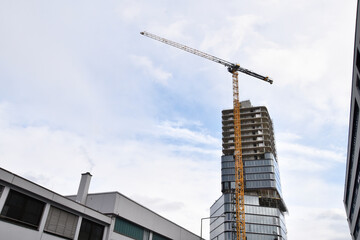 Fototapeta na wymiar Crane and building under construction , modern 