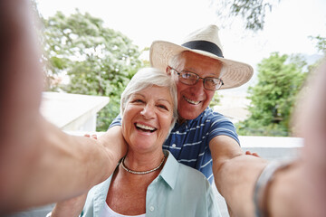Fototapeta premium Our sunday selfie. Shot of a happy senior couple taking a selfie.