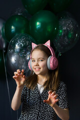 Naklejka premium Girl pretends to be a cat. Girl in headphones laughing