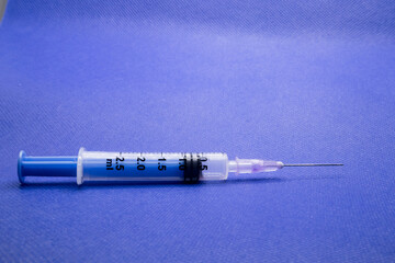 A syringe with blue background