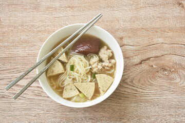 Vietnamese rice noodles or Pho with slice sausage and chop pork in soup on bowl