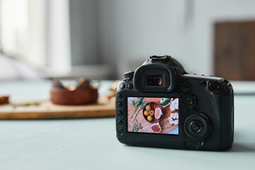 Close up of digital camera with food photography on screen in studio setup, copy space