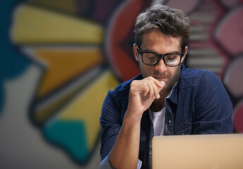 Getting his head around the project. Shot of a male entrepreneur working at his desk.