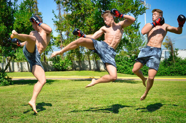 Muscle Athletic Man Jumping and doing martial arts moves and training out in nature.