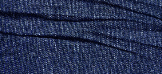 Naklejka premium crumpled blue jean texture background