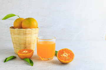 .fresh orange juice with orange fruit in basket