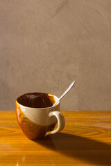 Ceramic cup with spoon still life