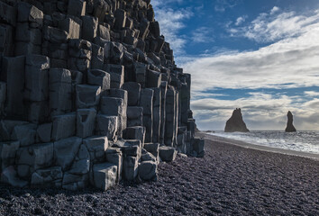 The famous Black Sand ocean Beach, mount Reynisfjall and Picturesque Basalt Columns, Vik, South Iceland.
