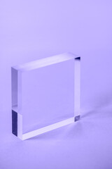 Acrylic Solid Display Block for Shop Windows on purple background, empty podium for product...