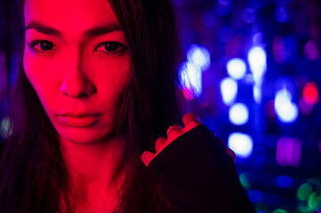 Portrait of a male transgender model in neon light.