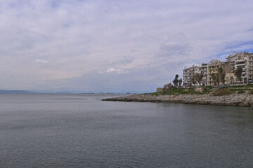 View of the coast of the city of Piraeus with commercial broads in the sea.