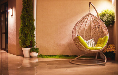 courtyard area with rattan chair at rainy evening
