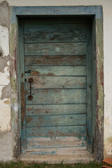 Fototapeta na wymiar Sunja, Croatia, 05,04,2021: Old wooden rustic doors on rural home wall.