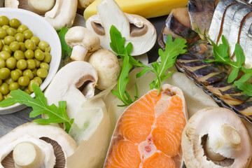 Healthy food, foods rich in vitamin D, omega 3 and protein, sea fish salmon mackerel, dairy products cheese, mushrooms, champignons, canned green peas